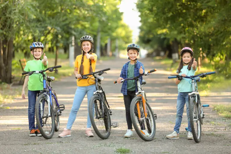 Cute children riding bicycles outdoors