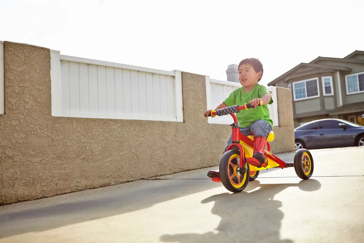 Boy cycling on driveway